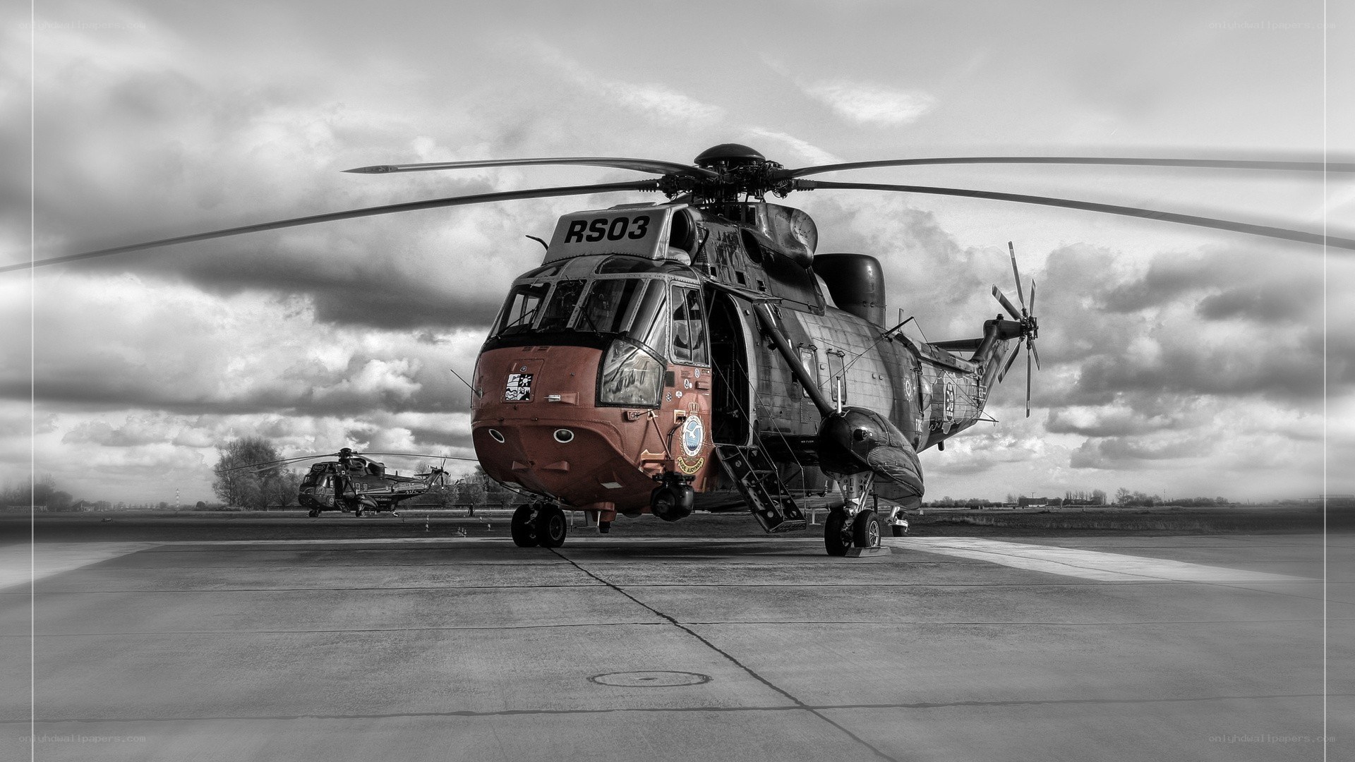 Helicopter on tarmac with another in background