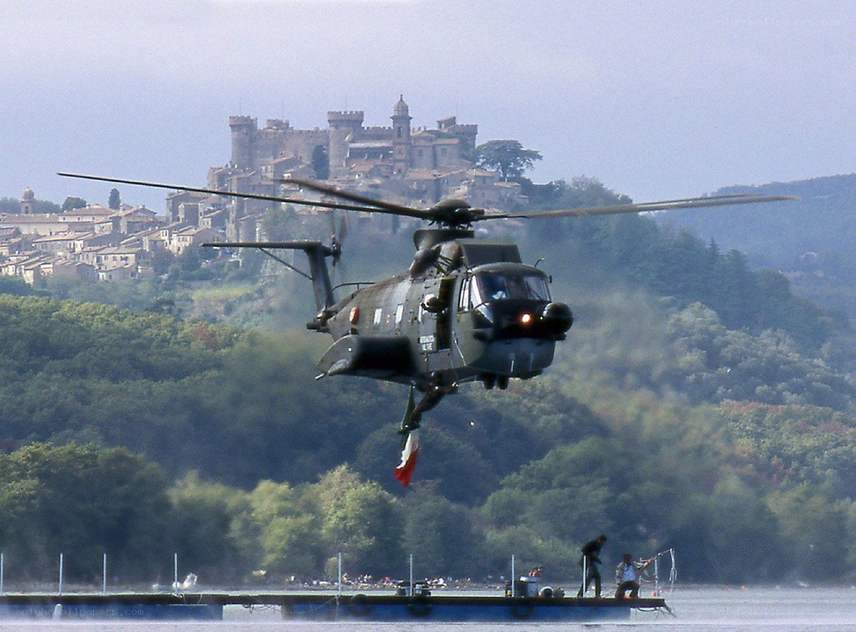 Helicopter over a lake with castle