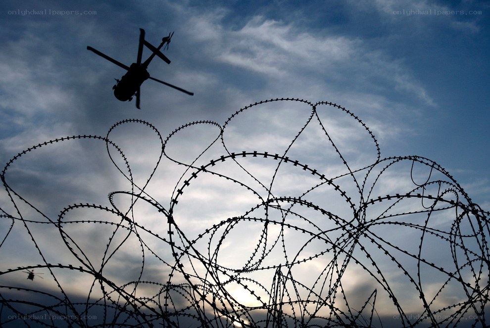 Helicopter over barbed wire