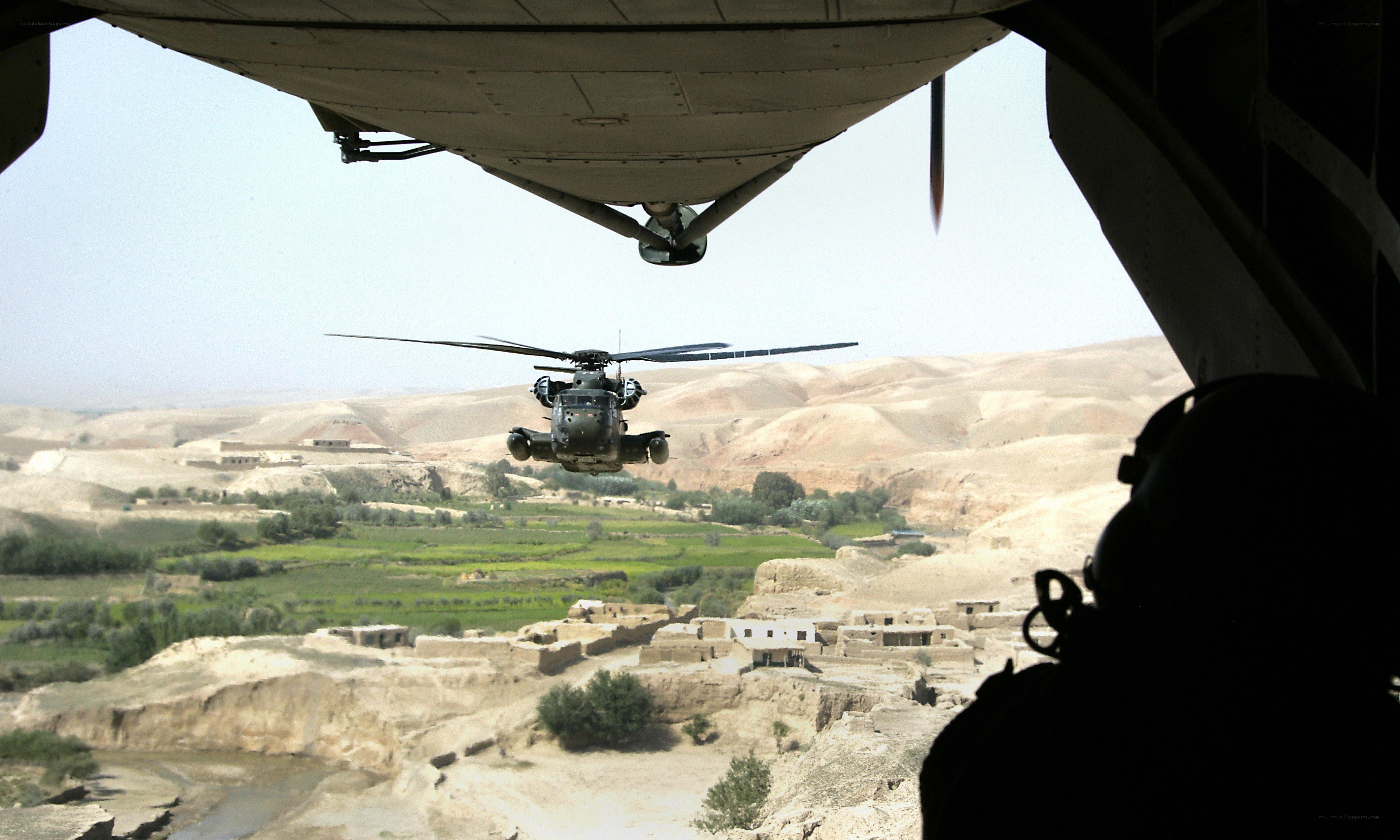 Helicopter over desert village
