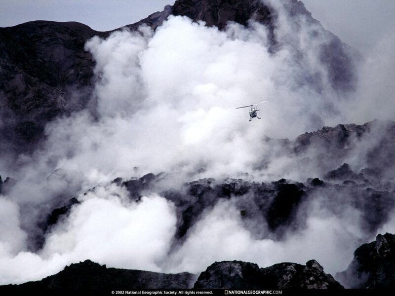 Helicopter over erupting volcano