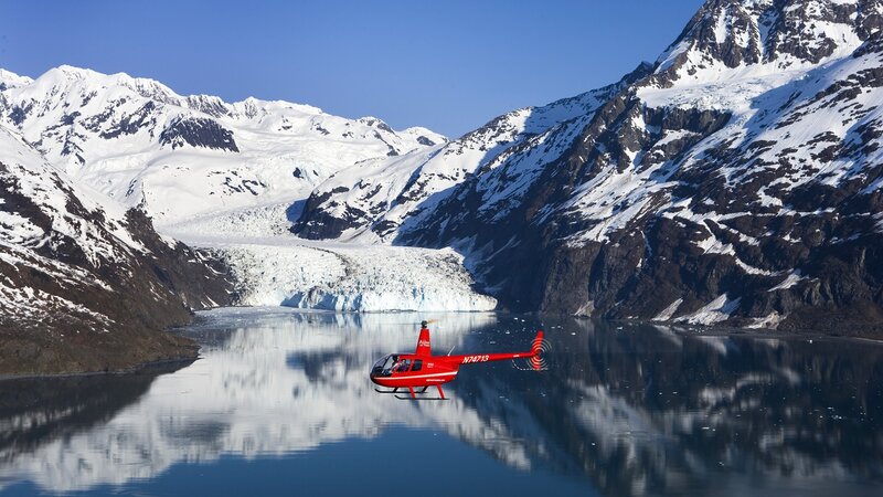 Helicopter over glacier lake