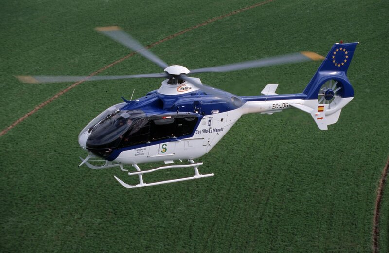 Helicopter over green field