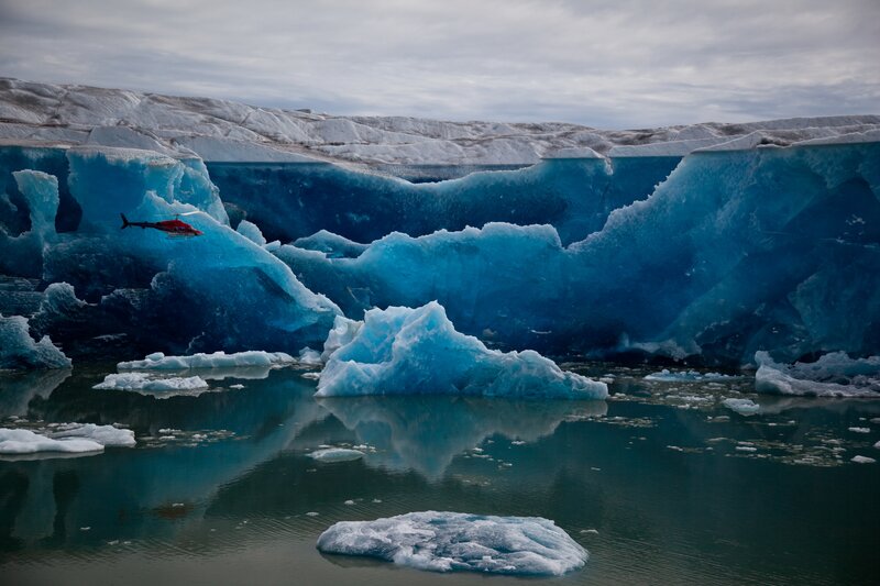 Helicopter over icebergs