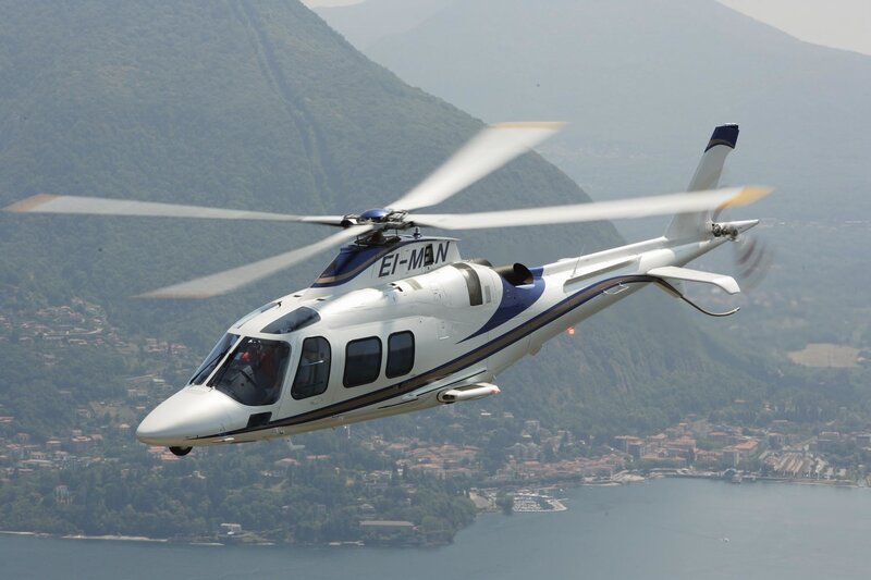 helicopter over lake and mountains