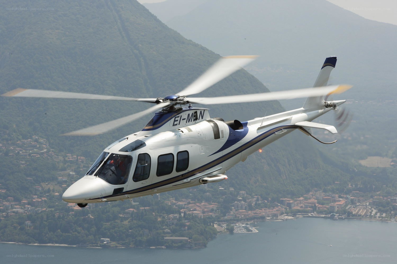 helicopter over lake and mountains