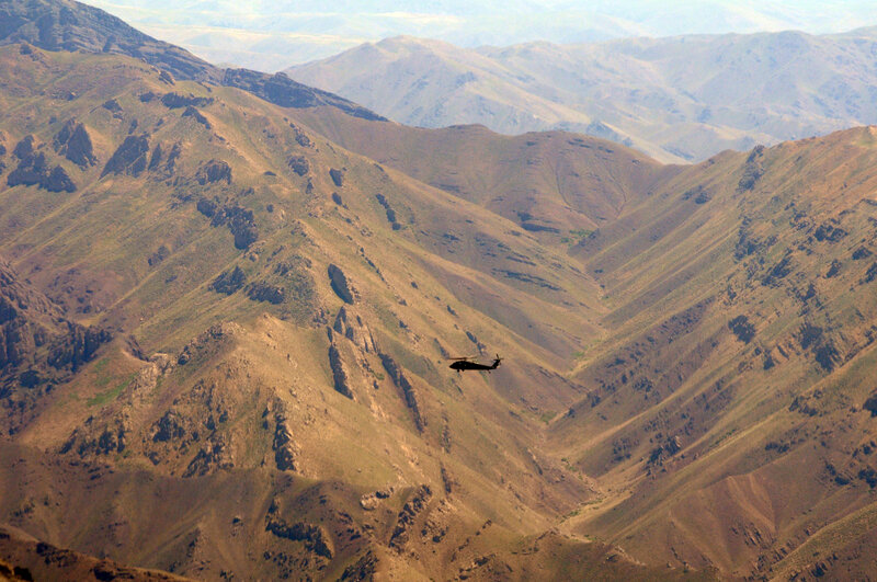 Helicopter over mountain valley
