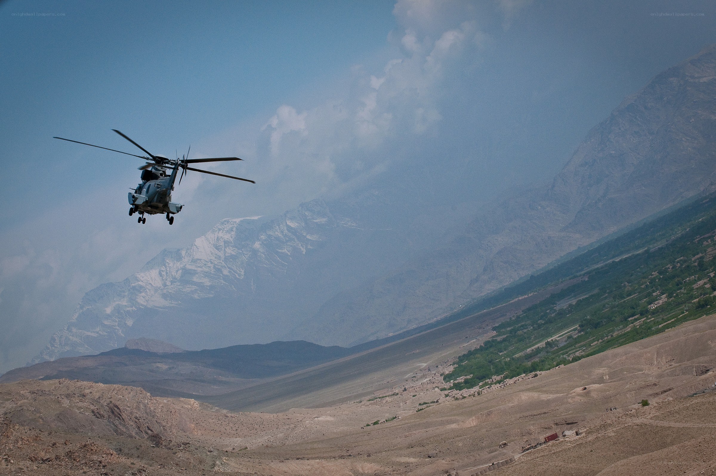 Helicopter over mountain valley