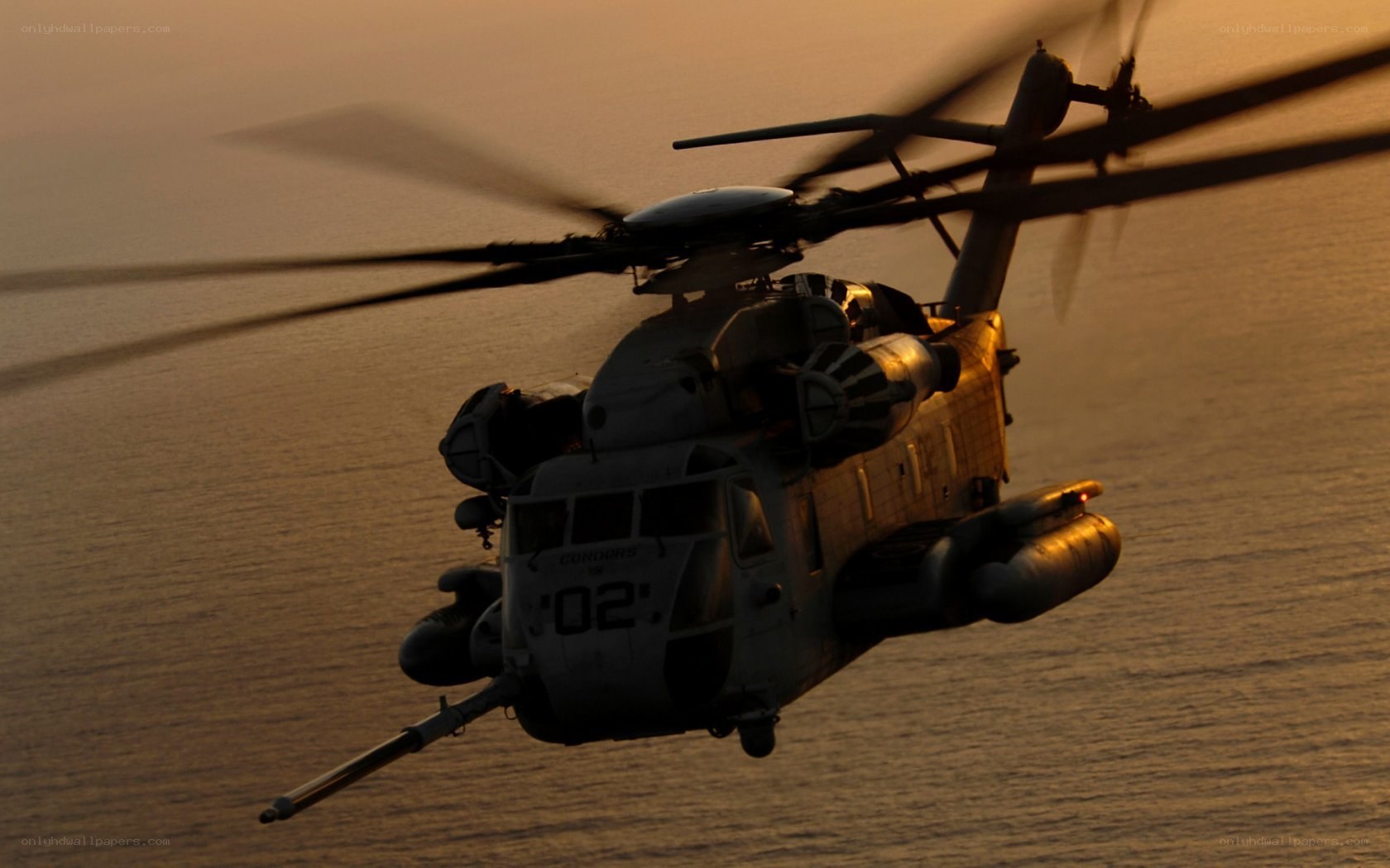 Helicopter over ocean at sunset