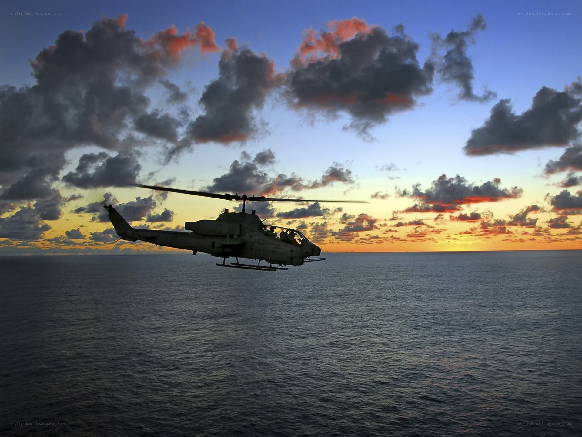 Helicopter over ocean at sunset