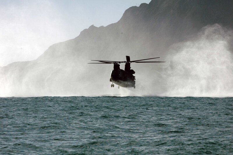 Helicopter over ocean near cliffs