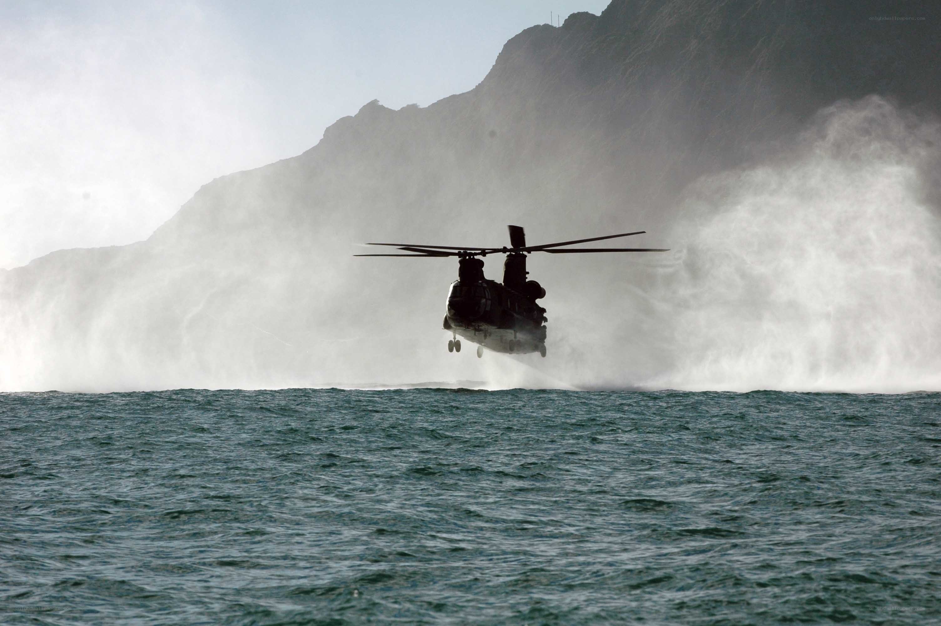 Helicopter over ocean near cliffs