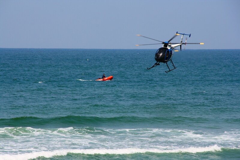 Helicopter over rescue boat