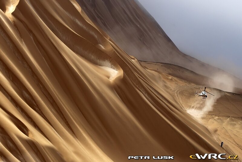 Helicopter over sand dunes