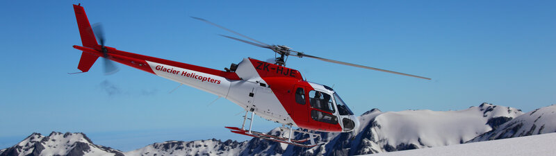 Helicopter over snowy mountains