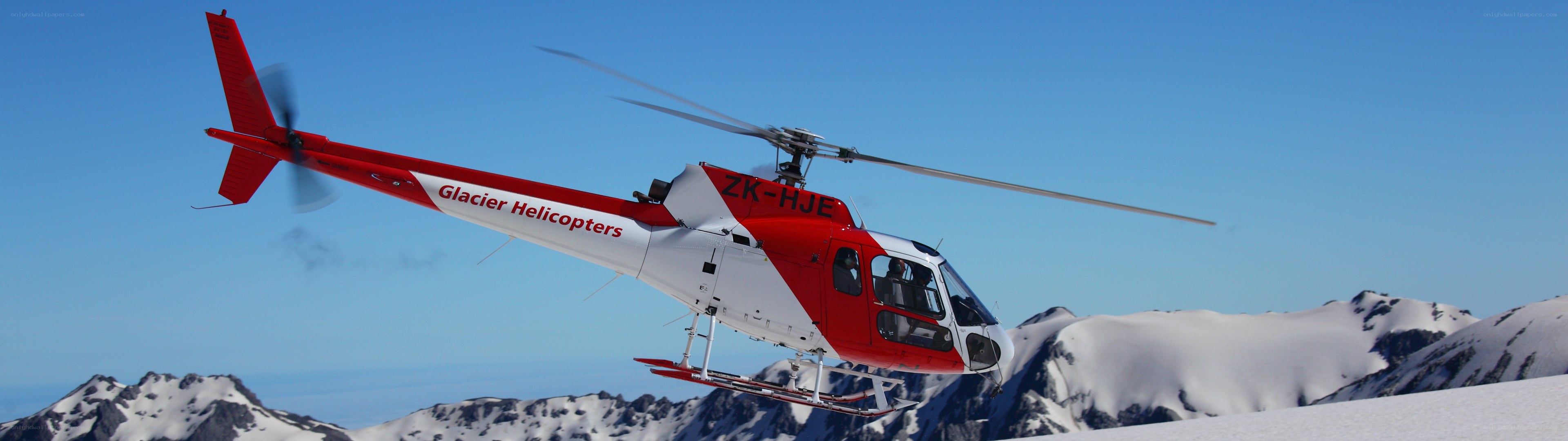 Helicopter over snowy mountains