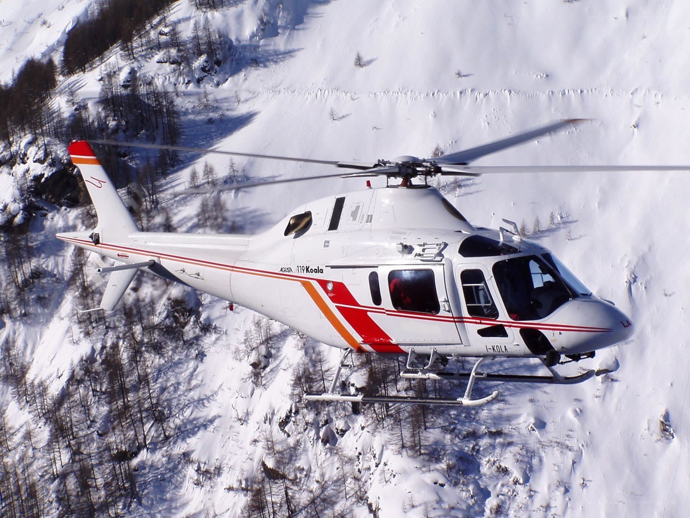 Helicopter over snowy mountains