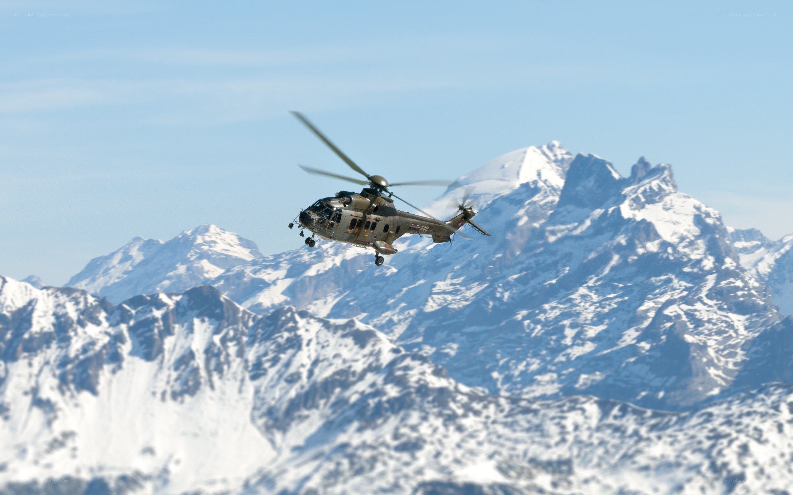 Helicopter over snowy mountains