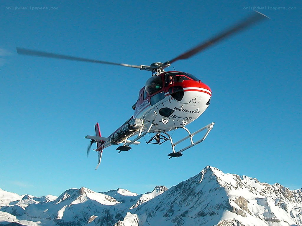 Helicopter over snowy mountains