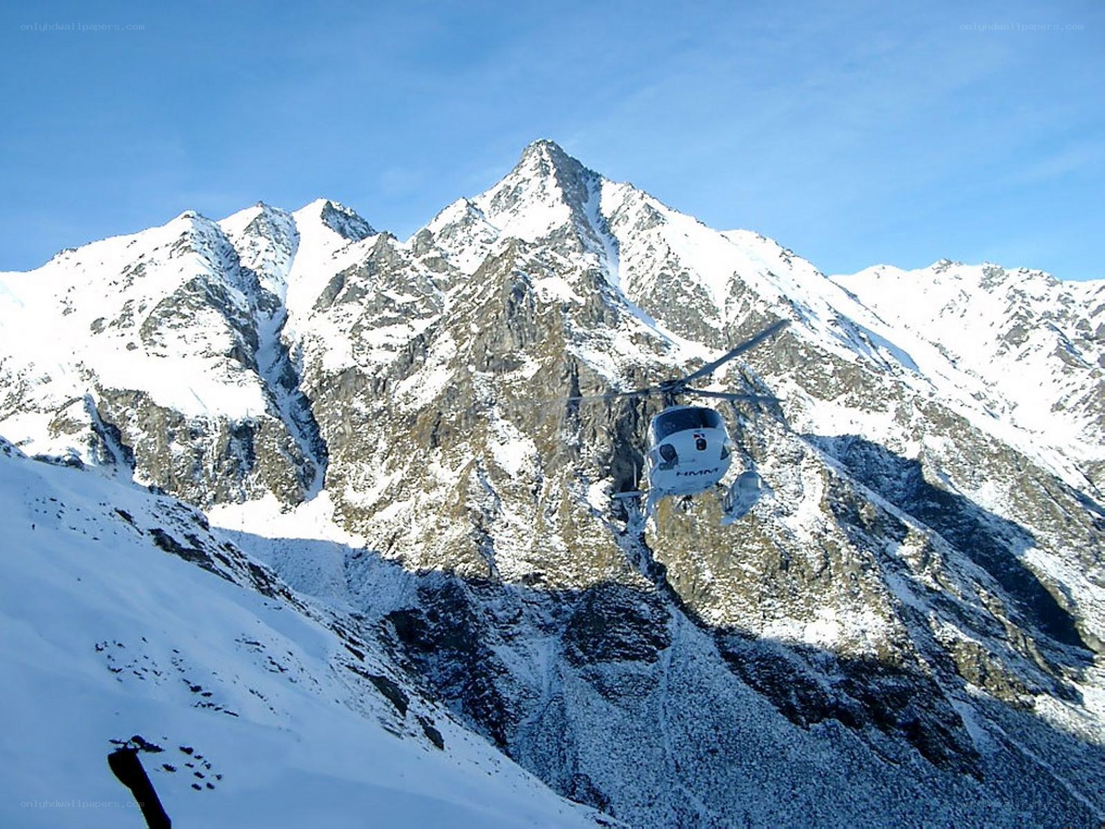 Helicopter over snowy mountains