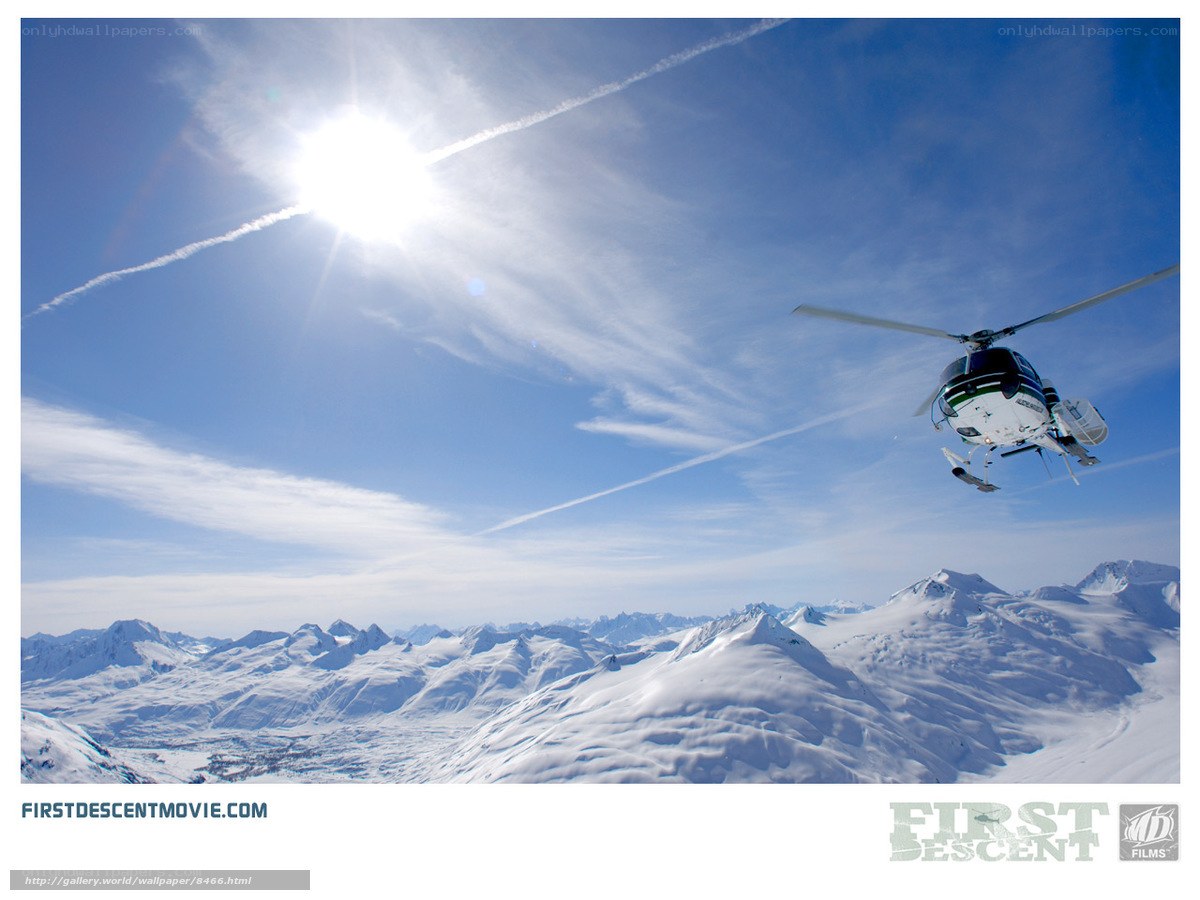 Helicopter over snowy mountains