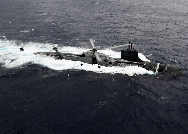 Helicopter over submarine