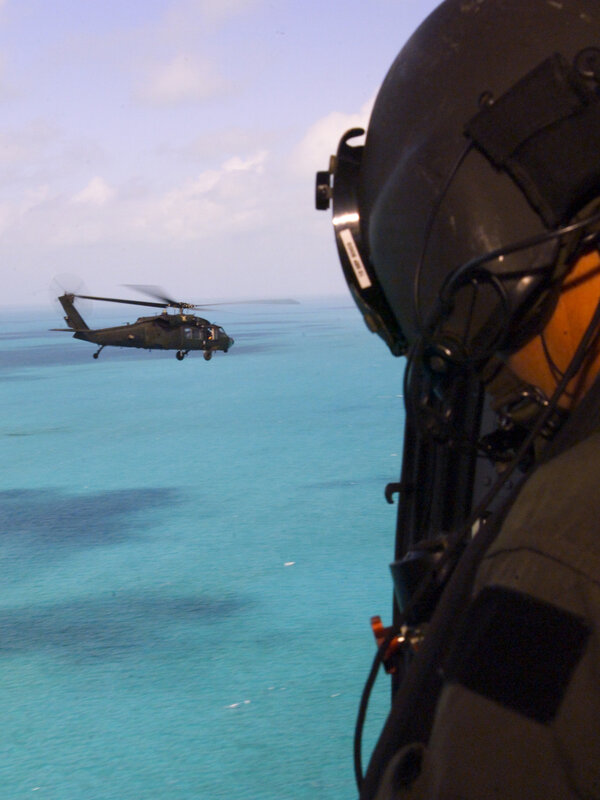 Helicopter over turquoise water