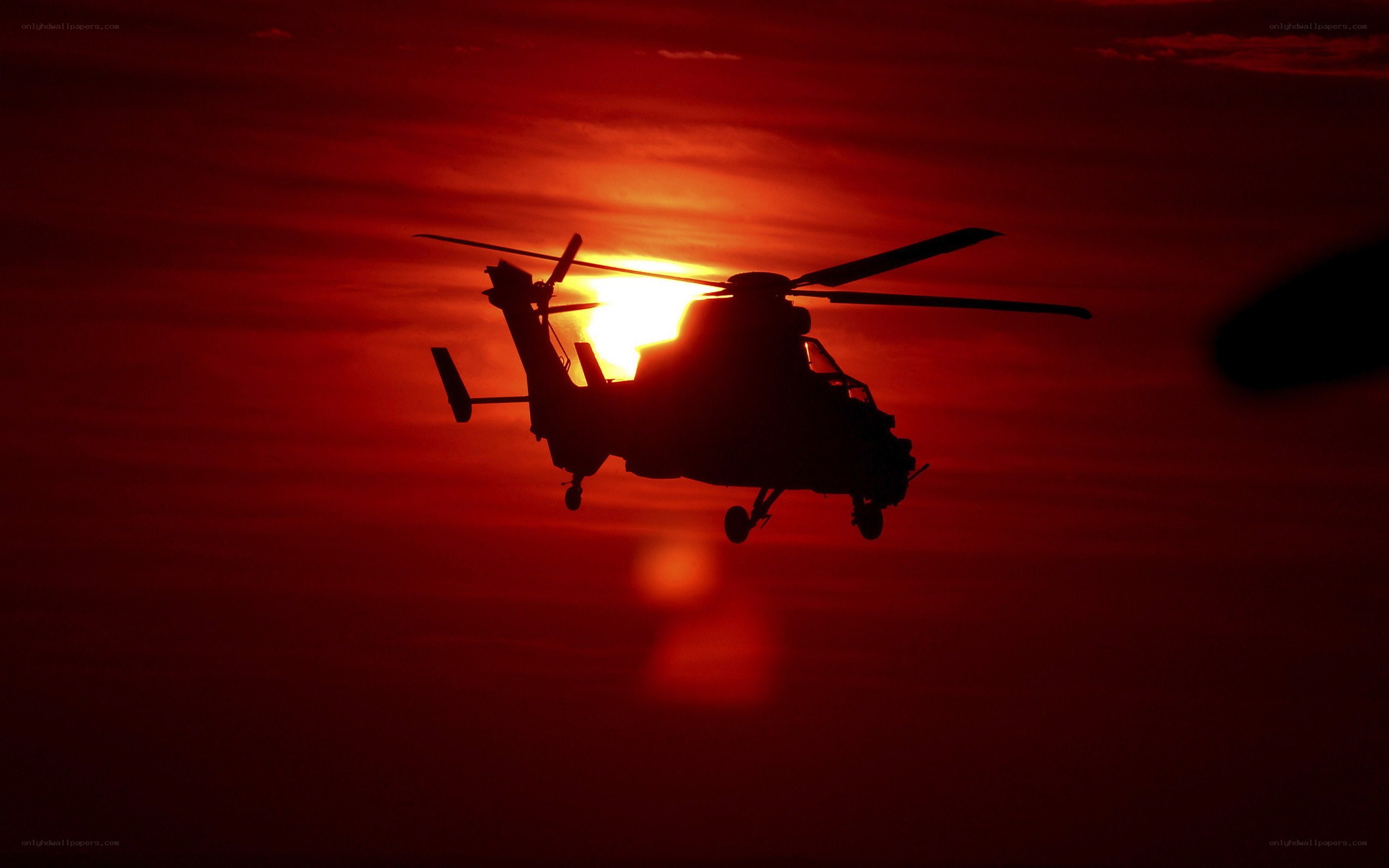 Helicopter silhouette at sunset
