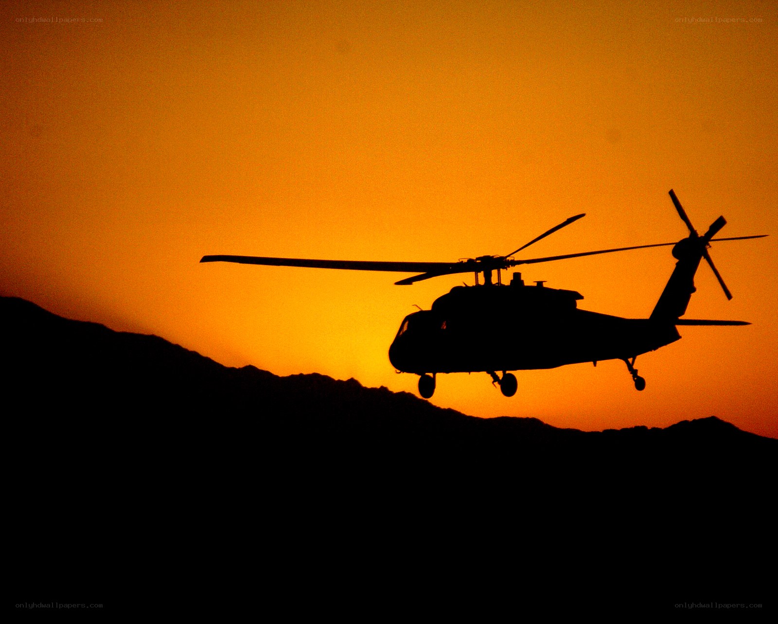 Helicopter silhouette at sunset
