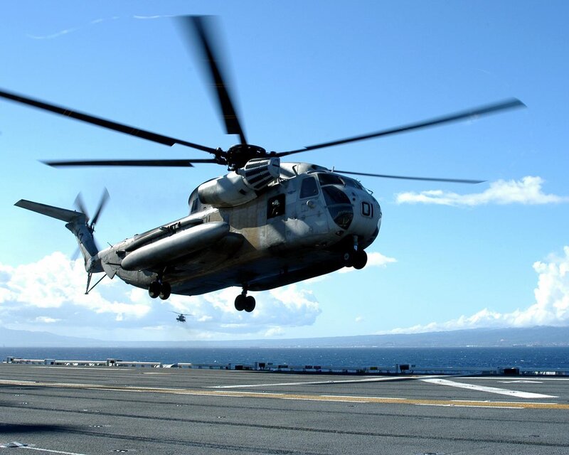 Helicopter taking off from aircraft carrier