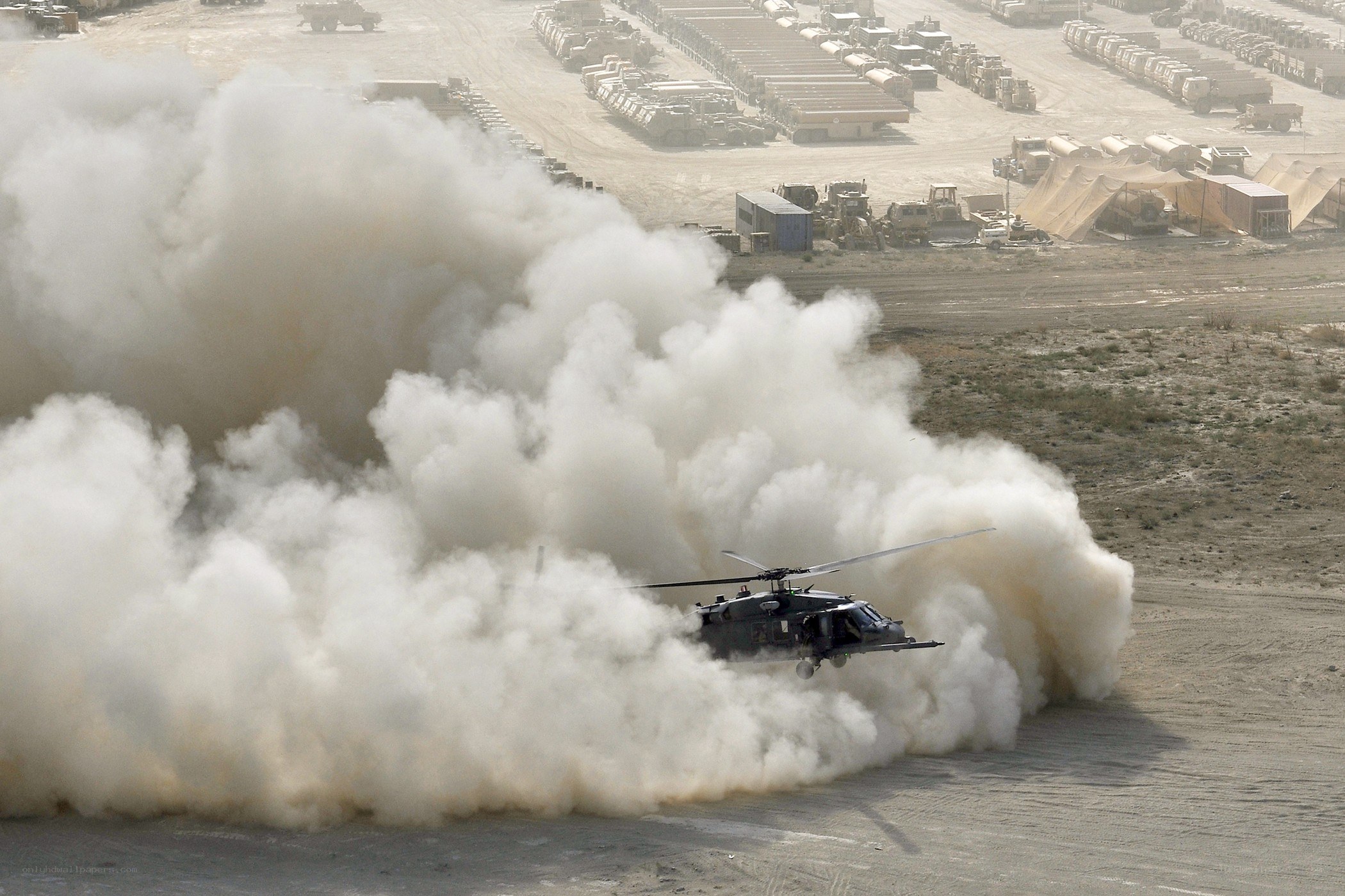 Helicopter taking off in desert