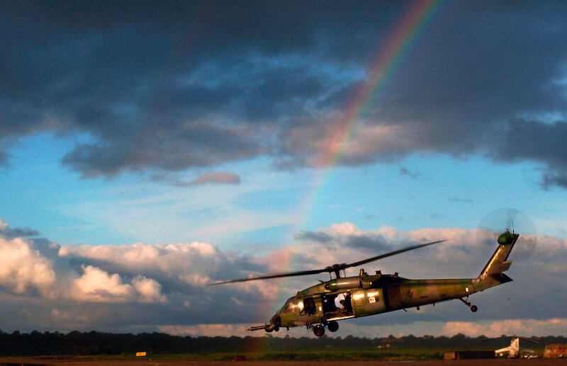Helicopter taking off with rainbow