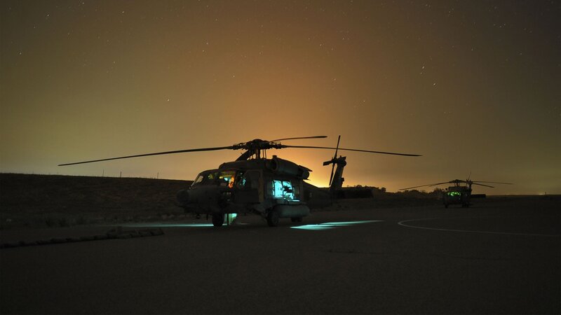 Helicopters at night on tarmac