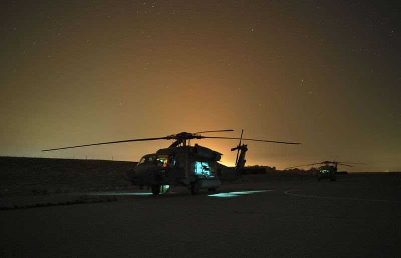 Helicopters at night on tarmac
