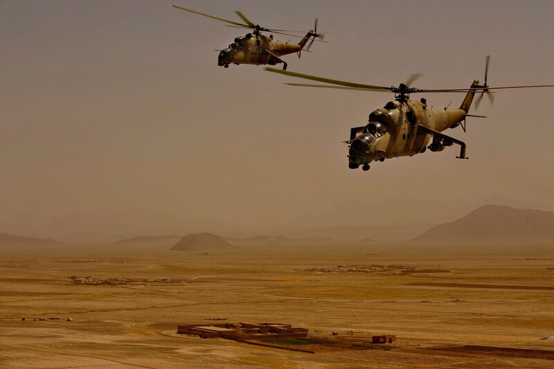 Helicopters flying over desert
