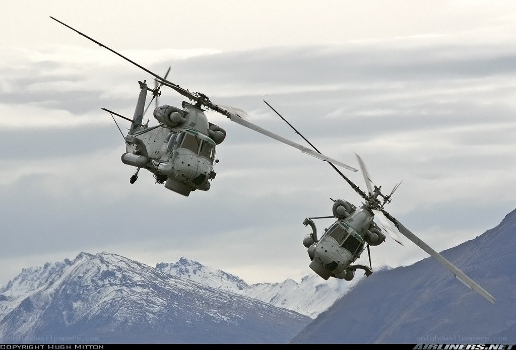 Helicopters flying over mountains