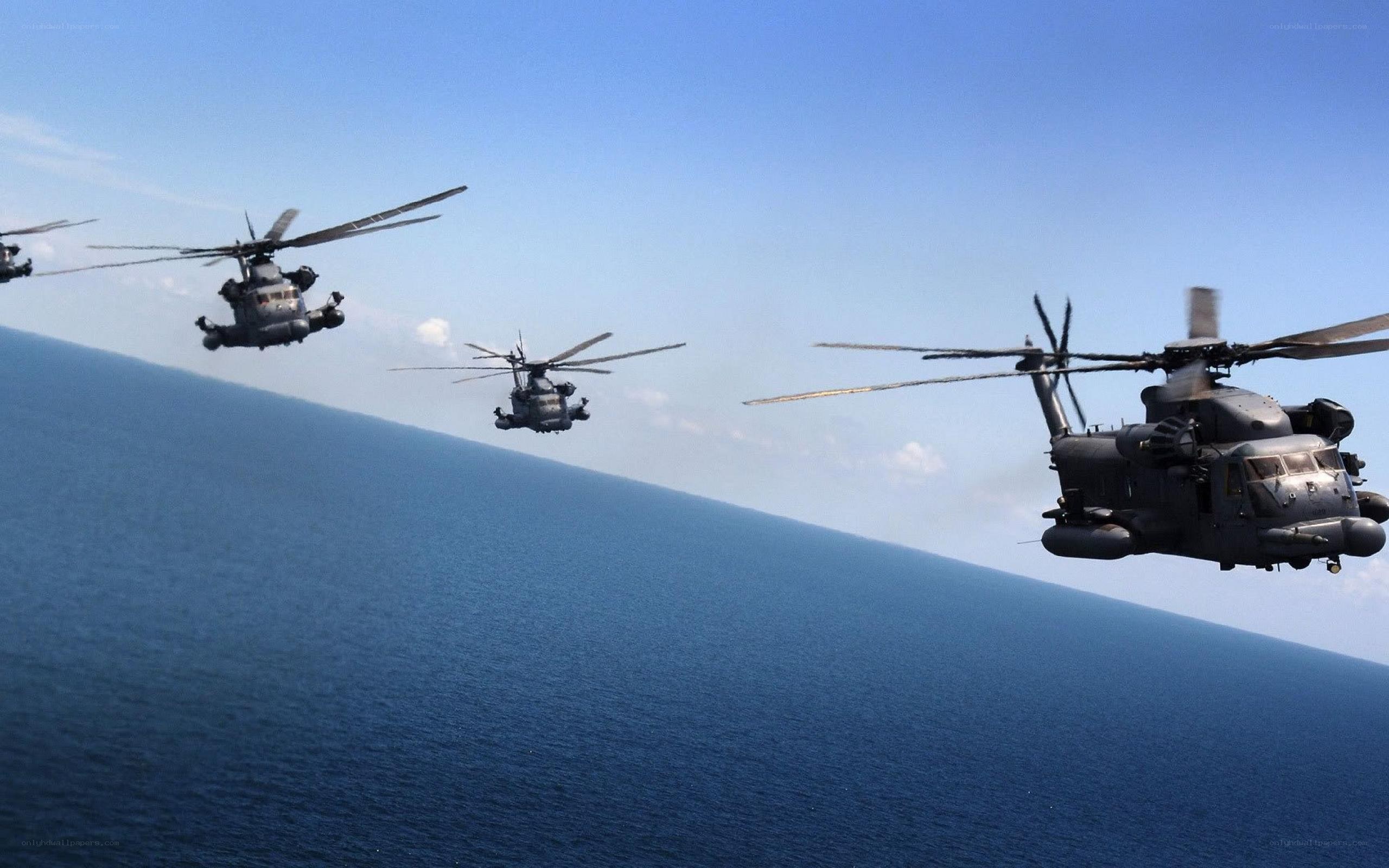 Helicopters flying over ocean