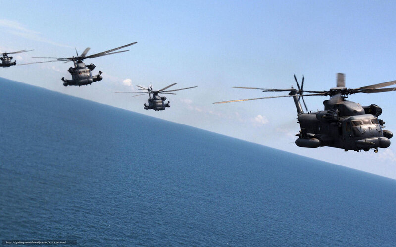 Helicopters flying over ocean