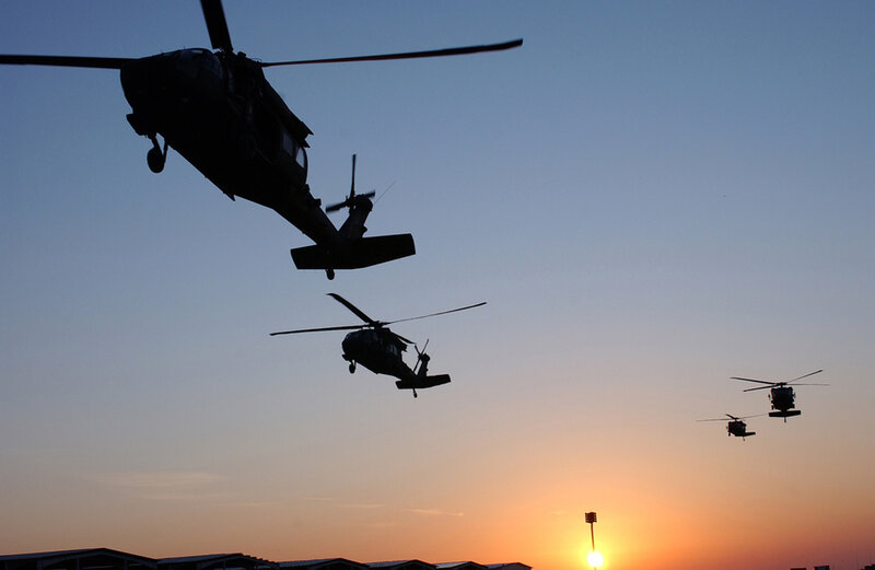 Helicopters in formation at sunset