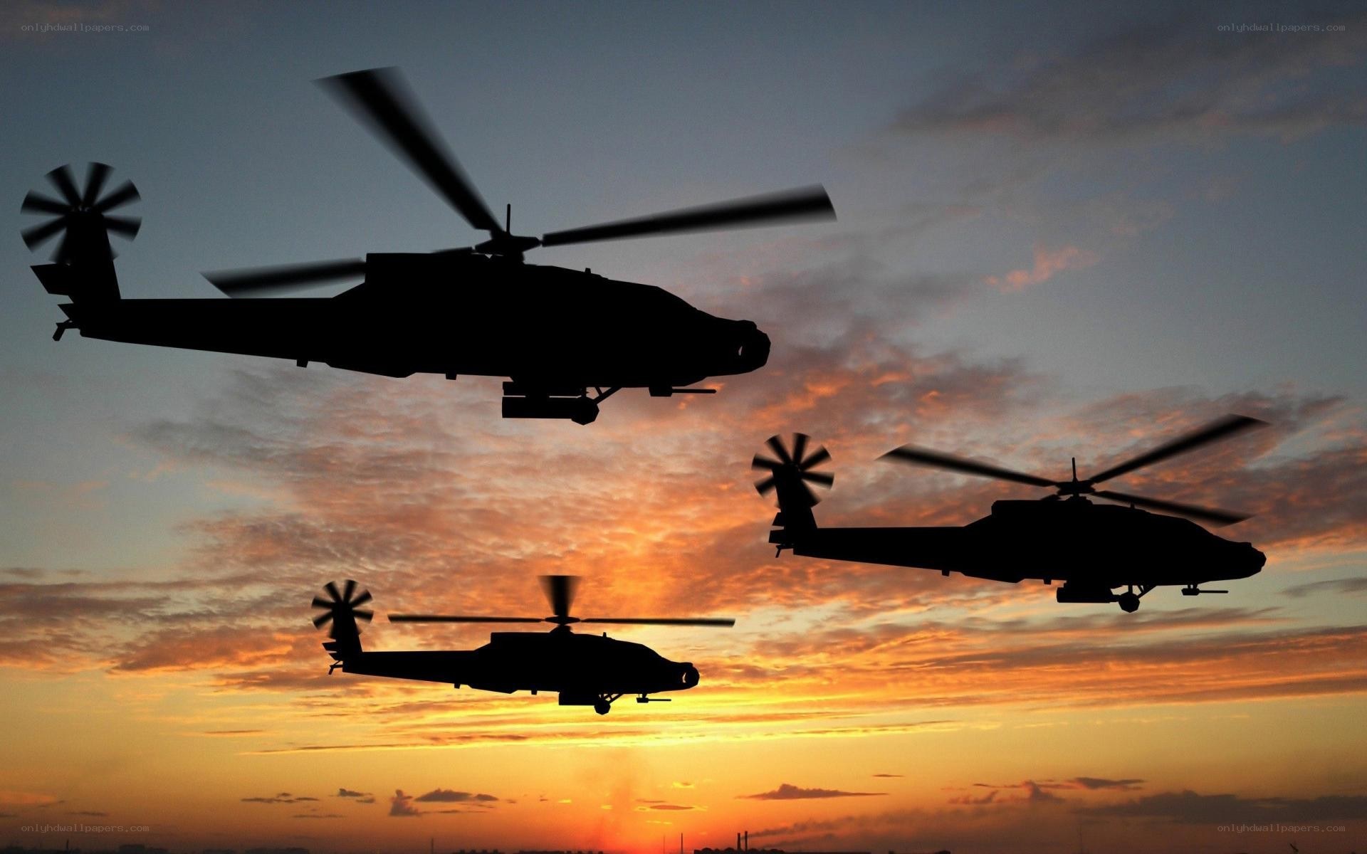 Helicopters in sunset sky