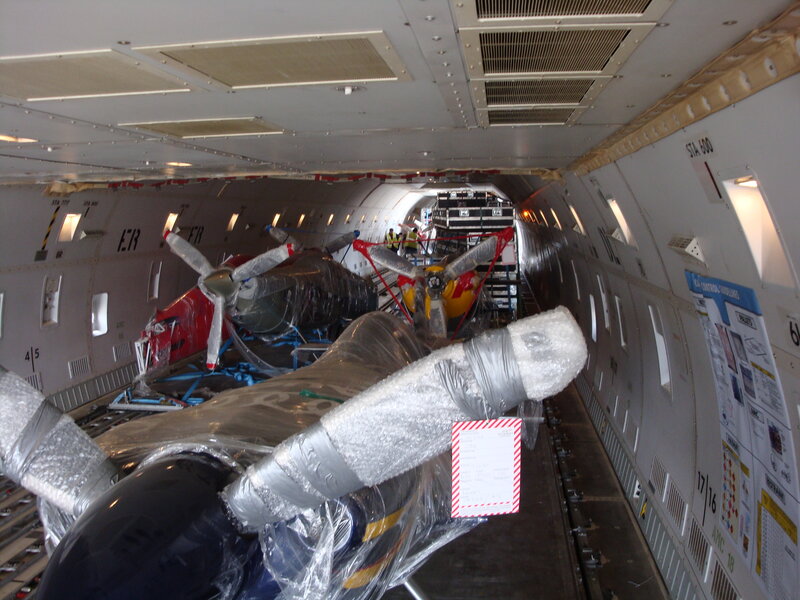 Helicopters loaded in cargo plane