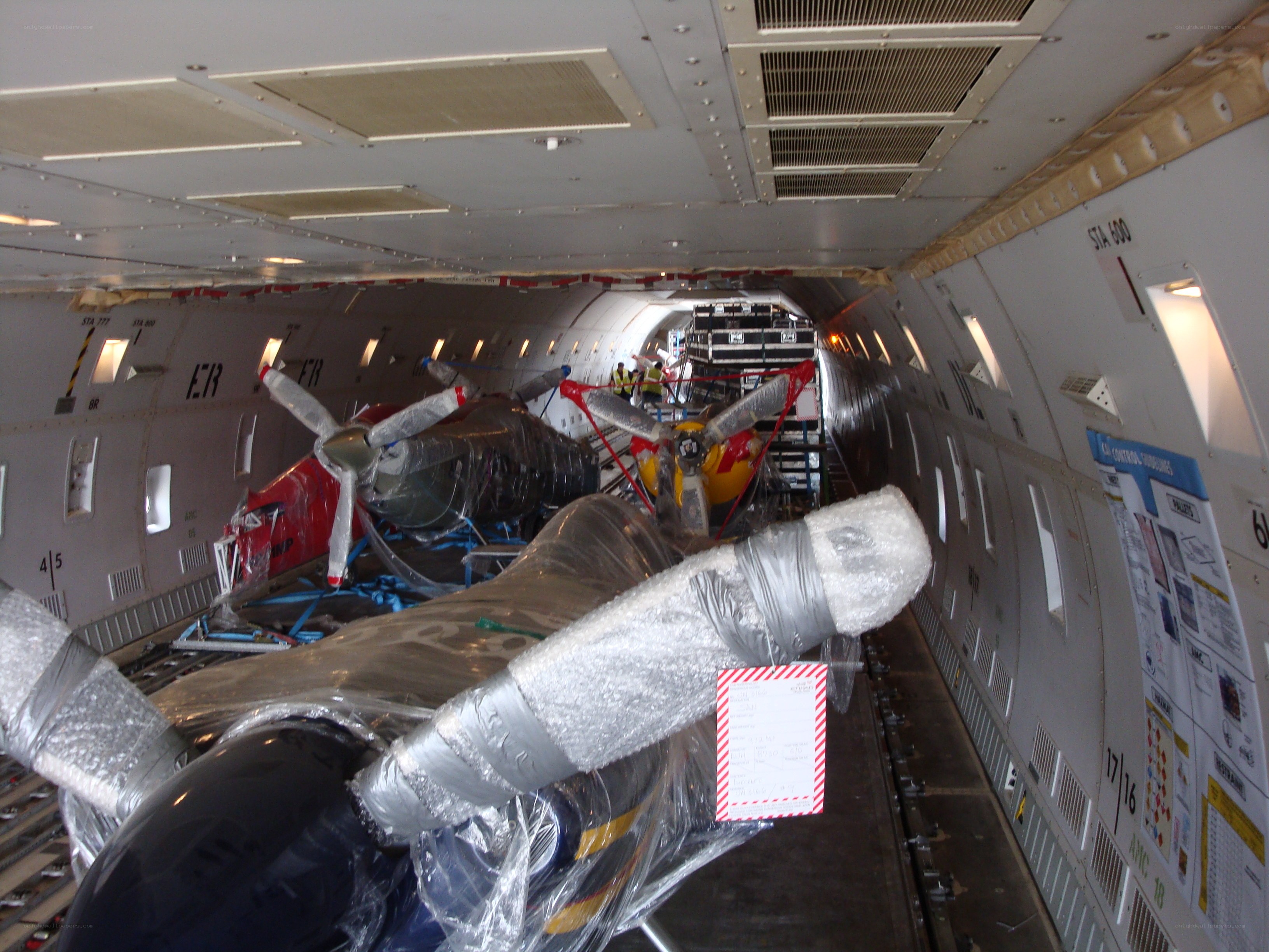 Helicopters loaded in cargo plane