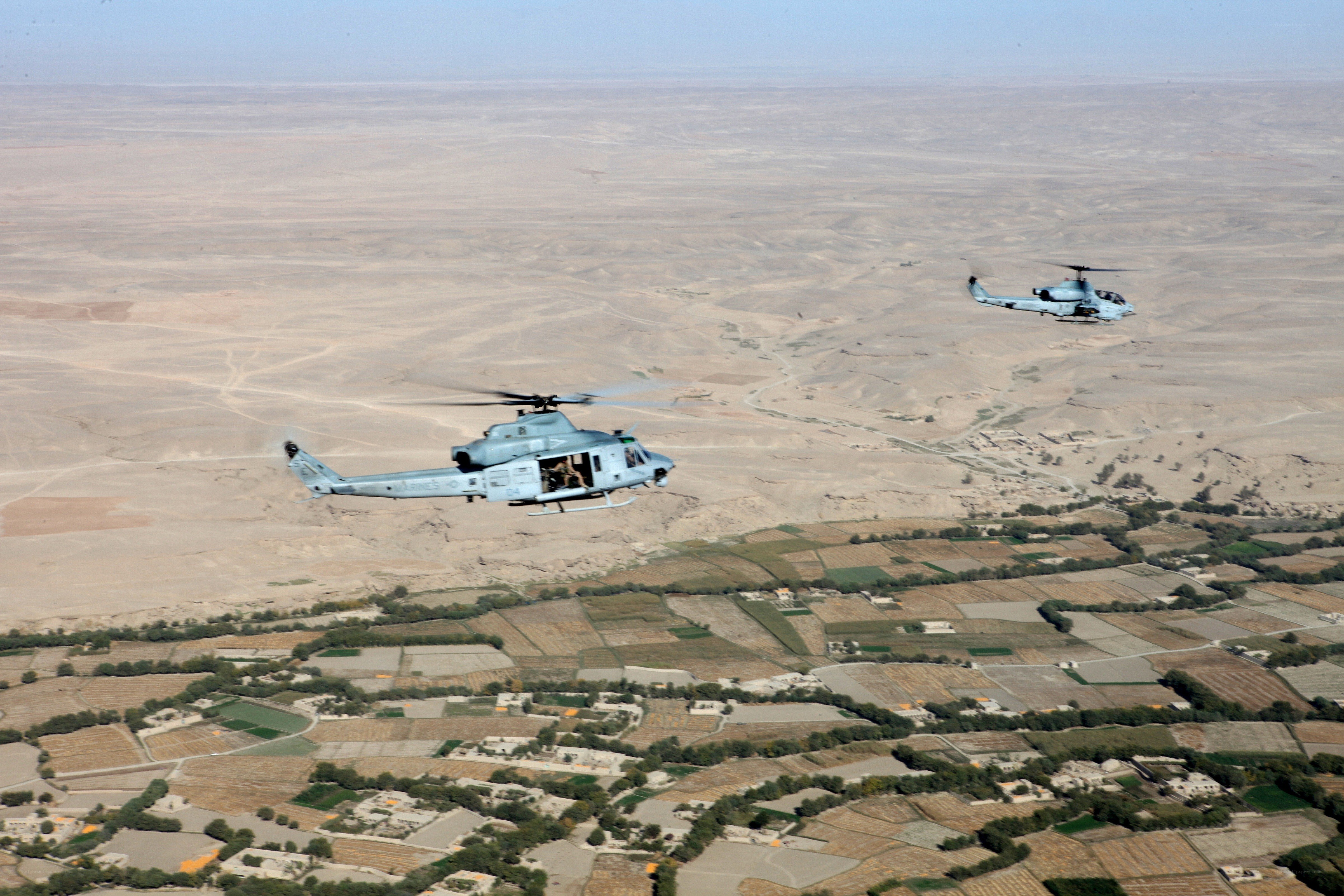 Helicopters over desert landscape
