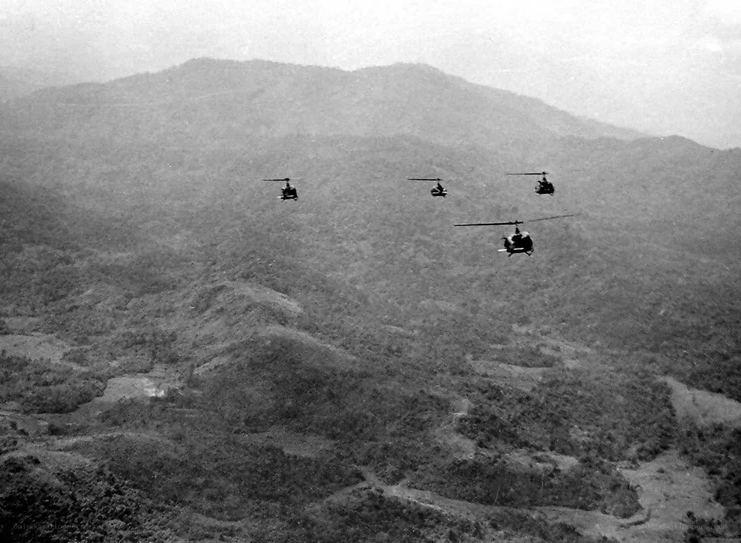 Helicopters over mountainous terrain