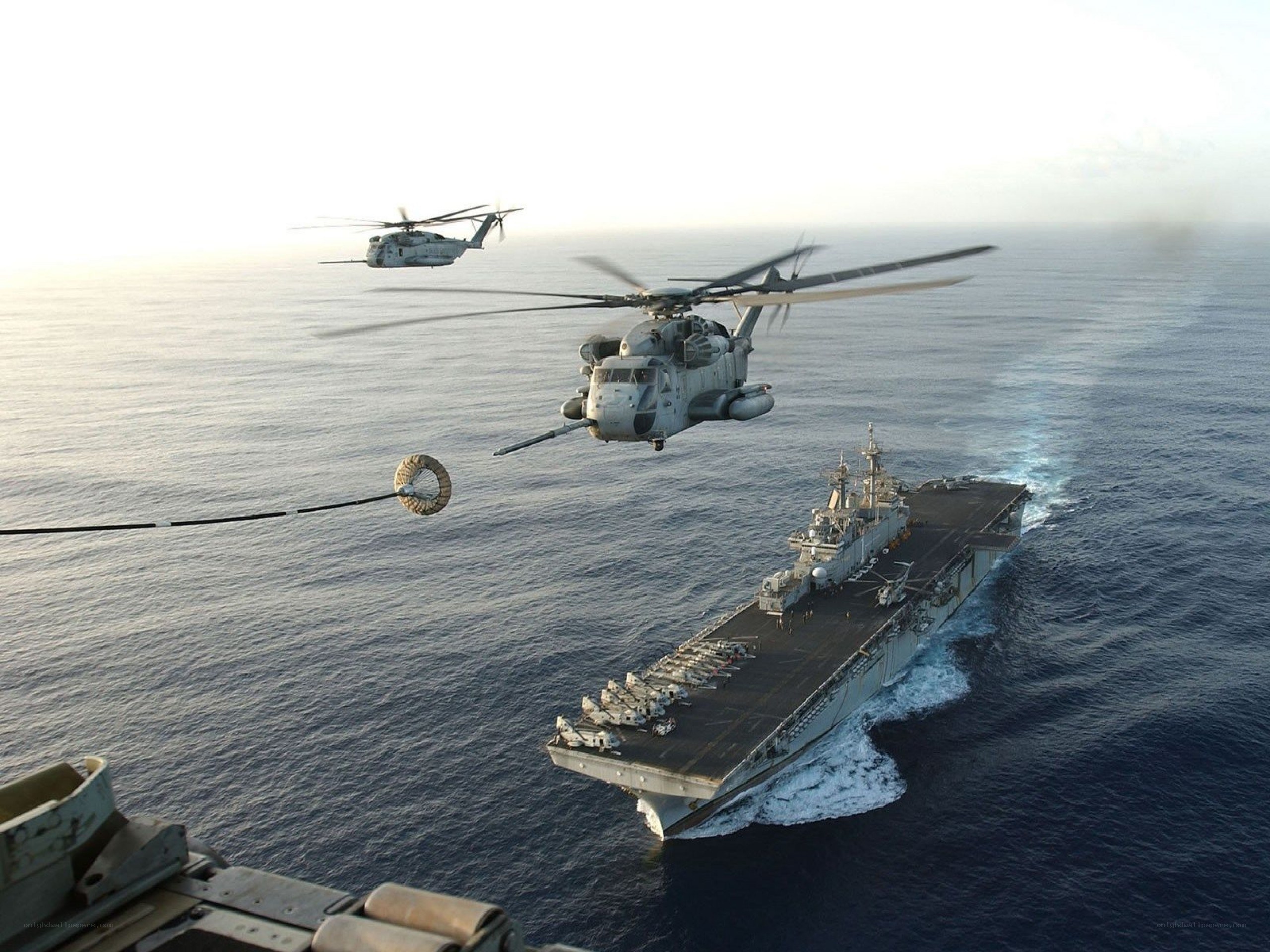 Helicopters refueling at sea