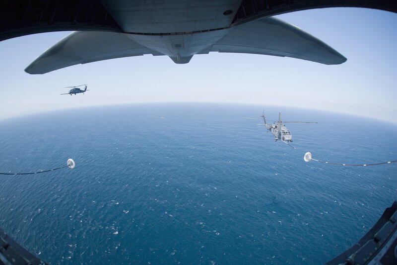 Helicopters refueling over ocean