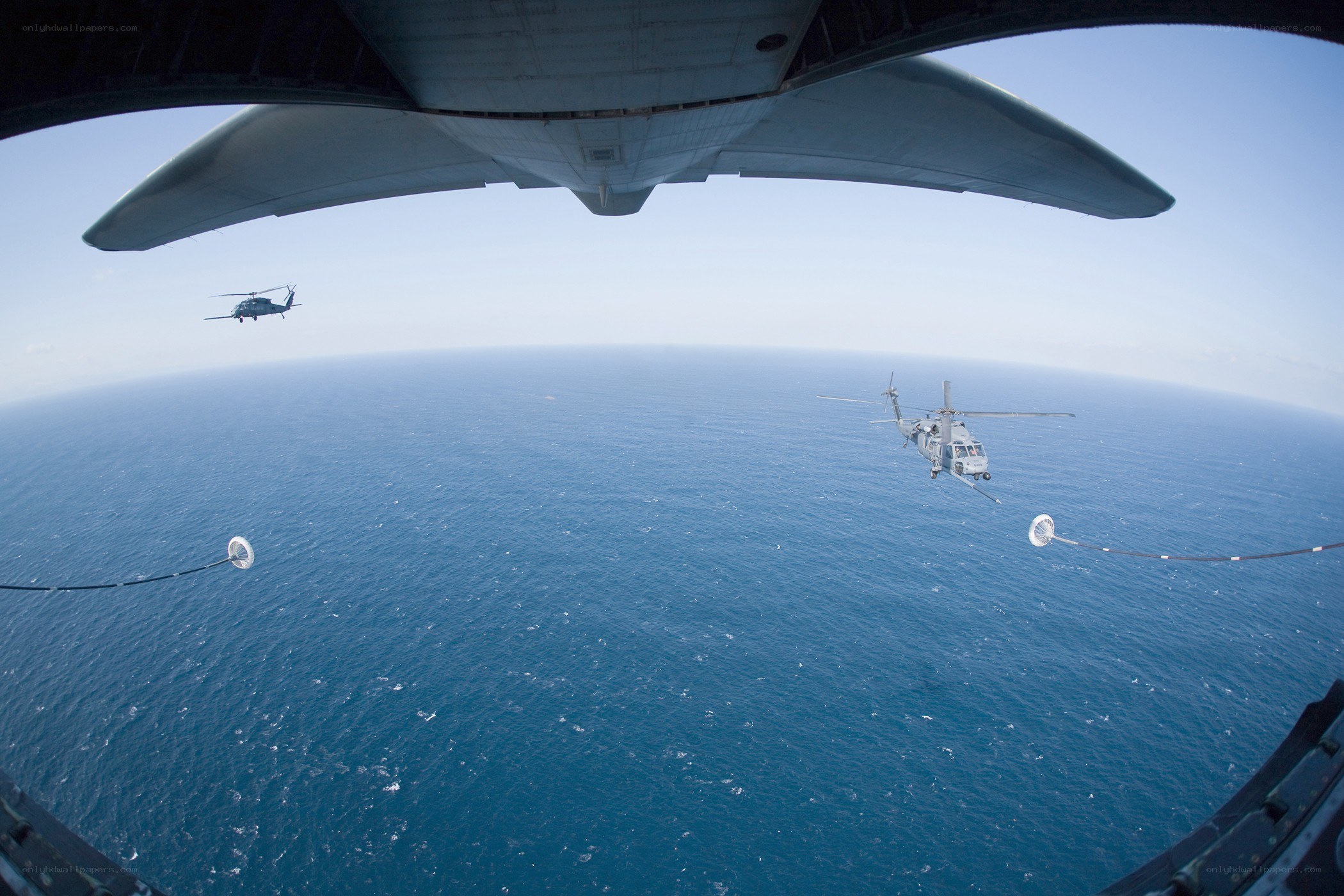 Helicopters refueling over ocean