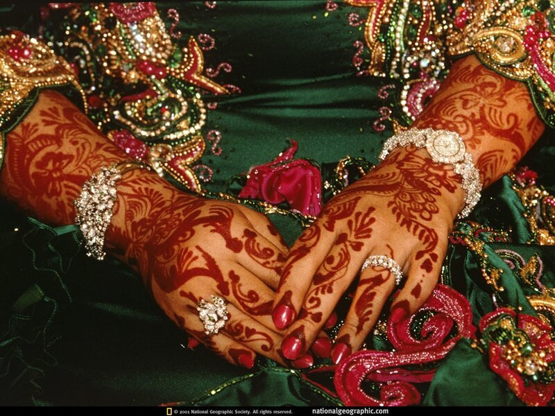 Henna-decorated hands in traditional attire