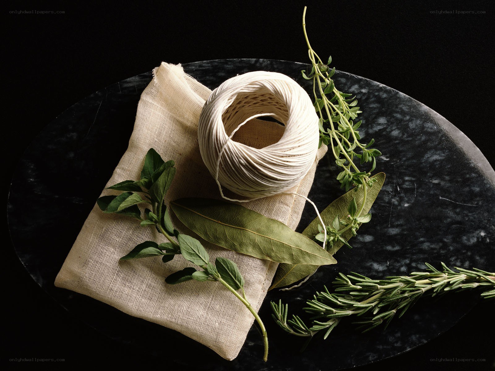 Herbs and twine on marble