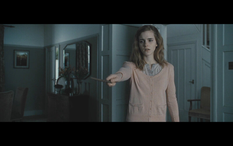 Hermione holding a wand